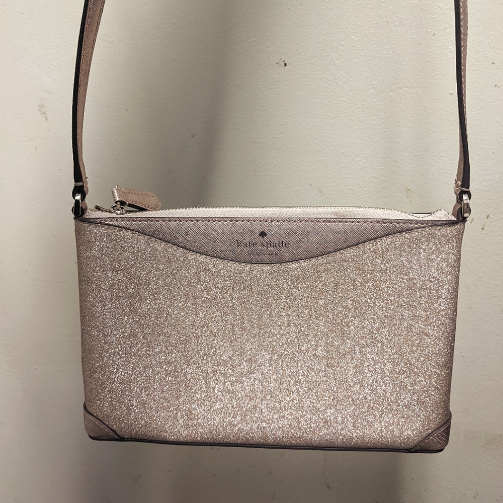 A rose gold shimmer cross body bag by Kate Spade